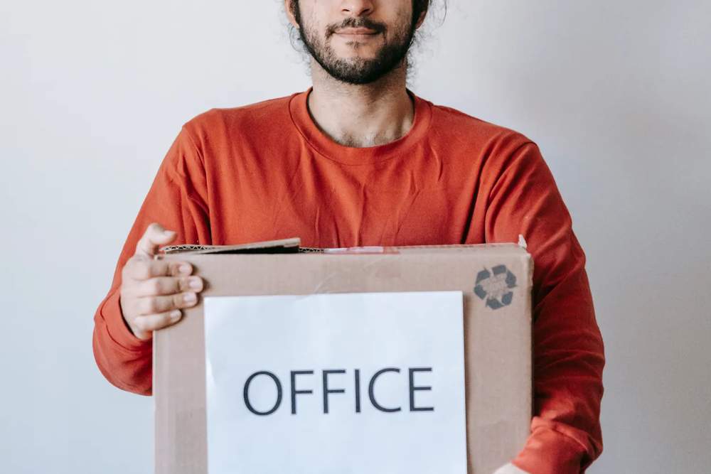 Office box being carried during a workplace move-out